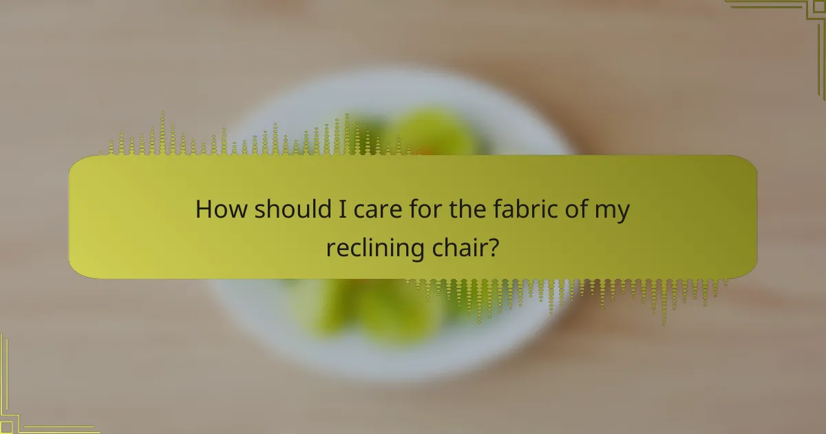 How should I care for the fabric of my reclining chair?